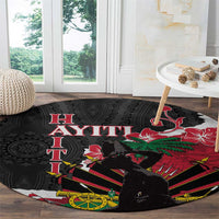 Round black carpet with Ayiti lettering and red hibiscus over green palm and stripe shapes