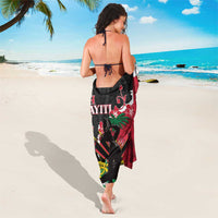 Black, red, and white Polynesian-pattern sarong worn as a skirt with floral and geometric print.