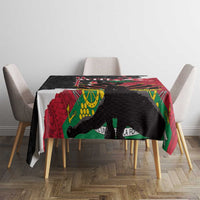 Black and red tablecloth with polynesian animal and wave motifs on dining table