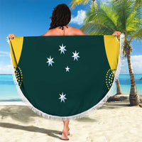 Round dark green cricket beach blanket with white fringe, white star emblems on yellow panels