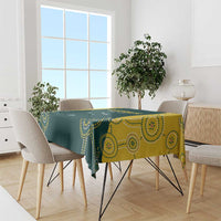 Cricket tablecloth draped on dining table, dark green with yellow dotted swirl pattern