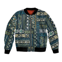 Blue patchwork bomber jacket with full front zip, ribbed cuffs, and multicolor ornate pattern
