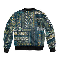 Blue patchwork bomber jacket with ribbed hem and cuffs, multicolor ornate geometric pattern