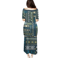 Long puletasi dress back view with short sleeves, boat neckline, and blue patchwork print