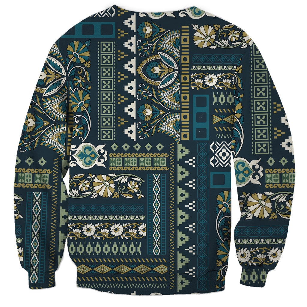 Unisex crewneck sweatshirt with blue patchwork medallion, paisley, and stripe panels