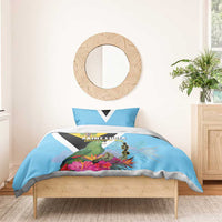 Sky blue bedding set with parrot, tropical flowers, yellow crest, and black-and-white chevron stripes