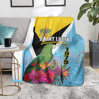 Tropical blanket draped on chair: sky blue, yellow/black/white diagonals, green parrot
