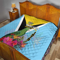Sky blue quilt with yellow and black V design, Saint Lucia crest, floral corner and 1979