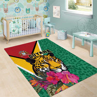Green area rug with jaguar face, tropical flowers, and bold GUYANA graphic