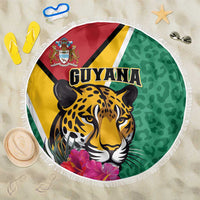 Round green beach blanket with jaguar face, floral accents, and white fringed edge