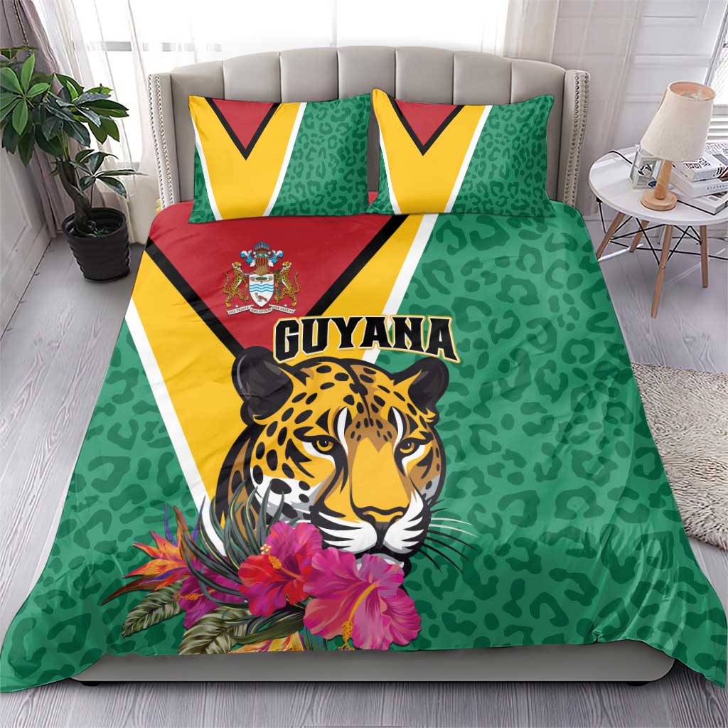 Green bedding set with jaguar face, floral accents, and Guyana logo on duvet & pillows
