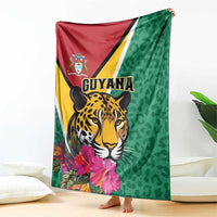 Folded green and red Guyana jaguar blanket with floral accents