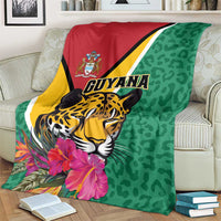Green Guyana jaguar throw blanket draped over armchair, pink flowers