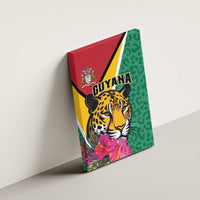 Side view of green canvas wall art with jaguar face artwork, pink flowers, and Guyana text