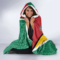 Green hooded blanket with jaguar and tropical flowers, red hood trim and multicolor panel