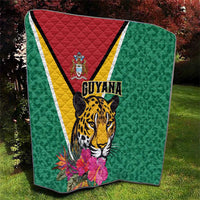 Green Guyana quilt with jaguar head, tropical blossoms, and red-yellow-white diagonal panel