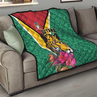 Green Guyana quilt draped on sofa with jaguar and tropical flowers, diagonal flag stripe