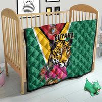 Green Guyana quilt on a crib with jaguar face and tropical flowers, diagonal stripe
