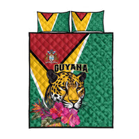 Green bed set quilt and two pillowcases with jaguar, Guyana text, and tropical flower print