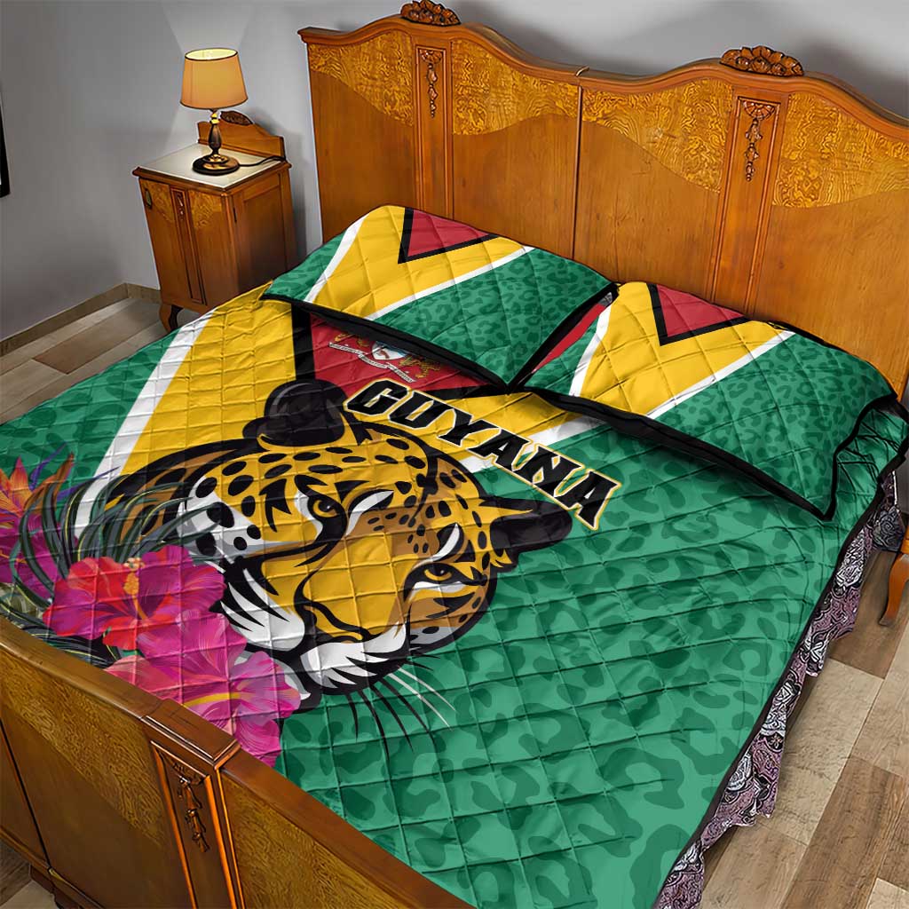 Green quilt and pillow set with jaguar graphic and Guyana lettering, plus tropical flowers