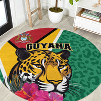 Round green circular rug with jaguar face and GUYANA text, purple flower accents.