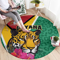 Round green circular rug with jaguar face, GUYANA lettering, yellow and red stripe border.