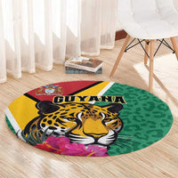 Round green circular rug with jaguar face, GUYANA lettering, purple tropical flowers.