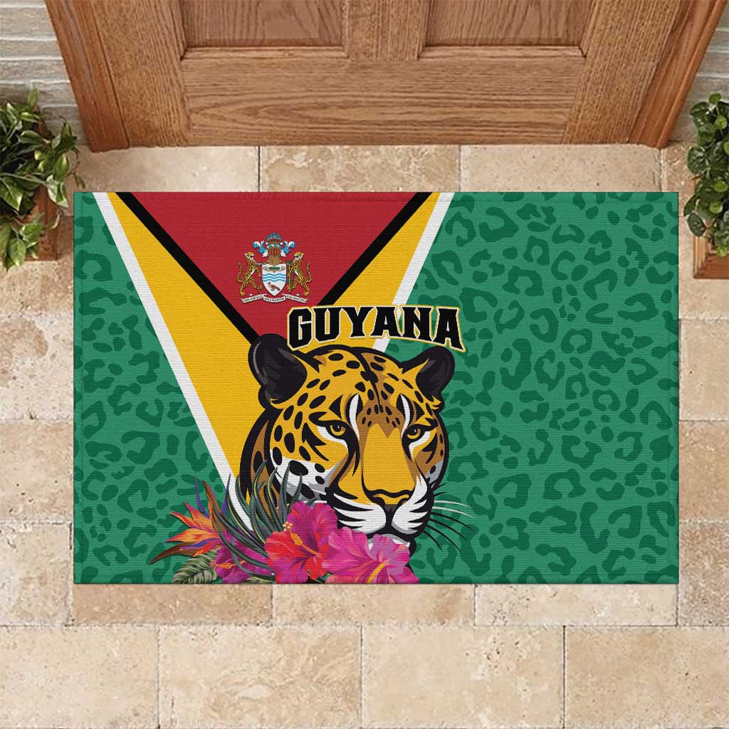 Green rubber doormat with jaguar graphic, Guyana text, and tropical flower border