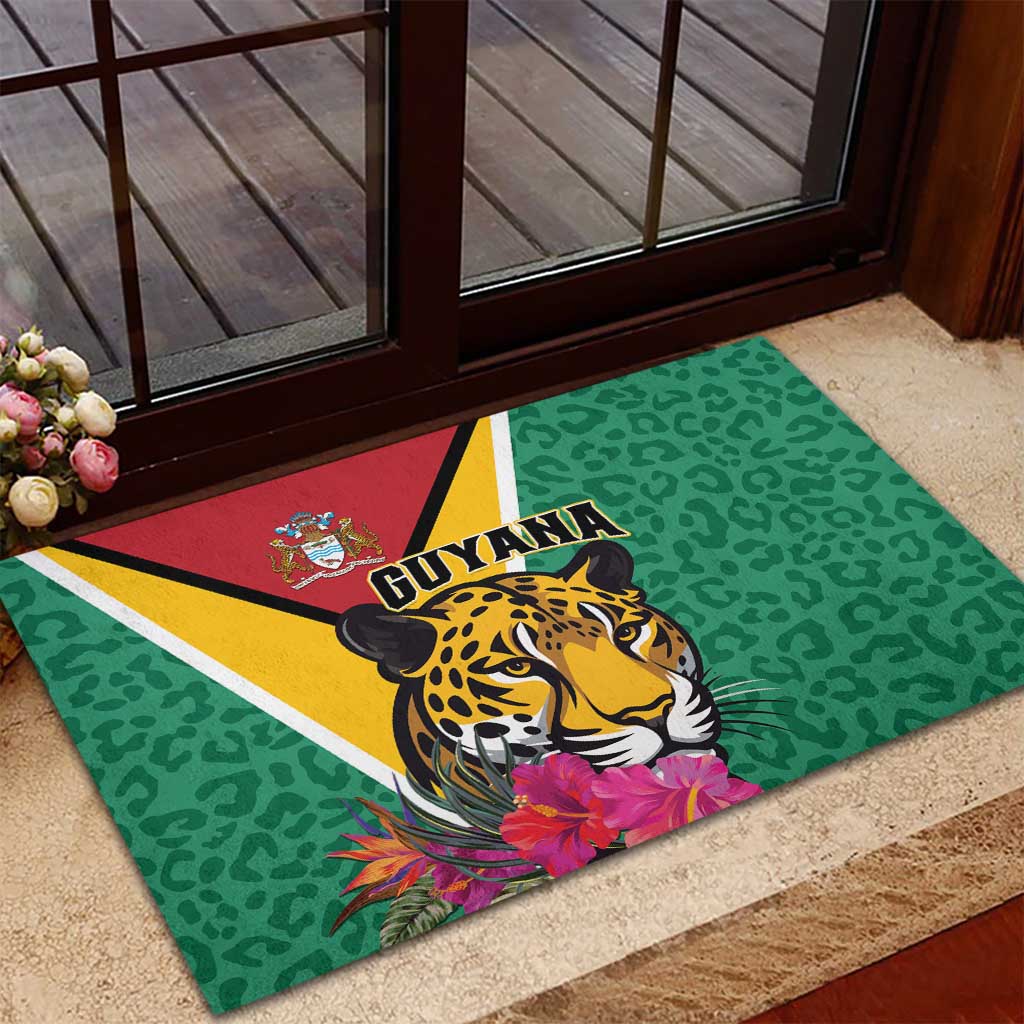 Green rubber doormat with jaguar artwork and Guyana flag stripes at entryway