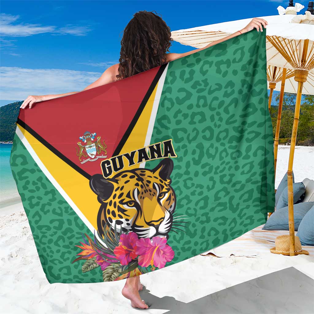 Green sarong with jaguar face and tropical flowers, multicolor triangular border