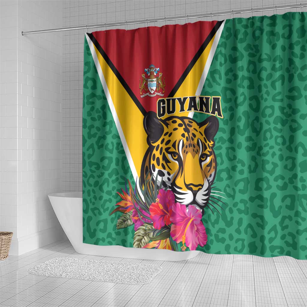 Green shower curtain with Guyana crest and jaguar artwork plus tropical flower blossoms