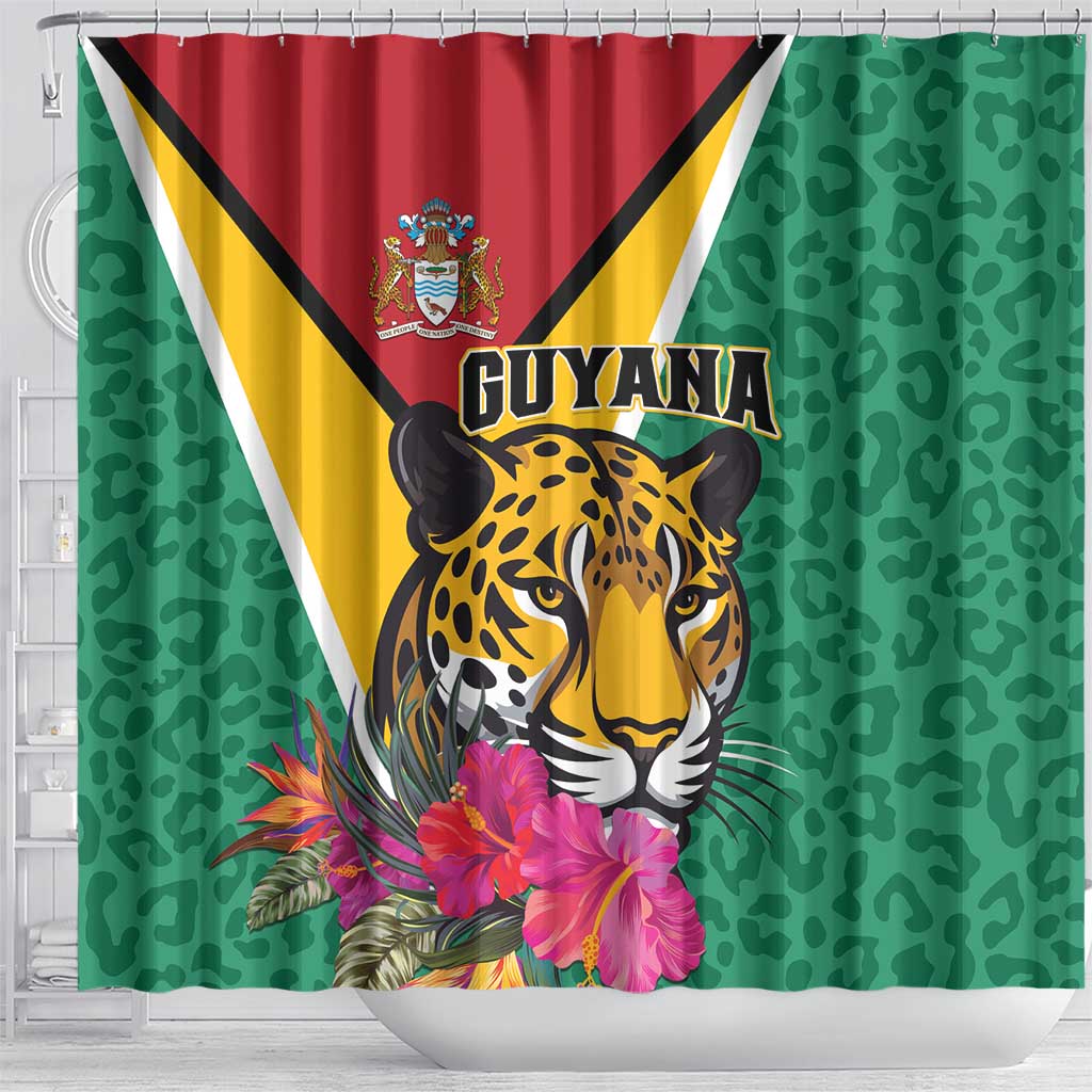 Green shower curtain with Guyana flag, detailed jaguar face, and pink tropical flowers