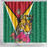 Green shower curtain with Guyana flag, detailed jaguar face, and pink tropical flowers