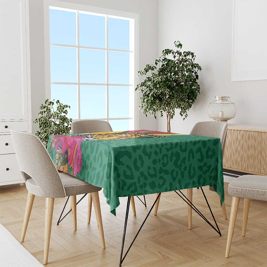 Green tablecloth with jaguar face, tropical flower accents and bold border