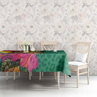 Green tablecloth with jaguar and tropical flower print, draped on dining table