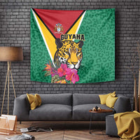 Green wall tapestry with jaguar portrait, Guyana crest, and pink tropical flowers