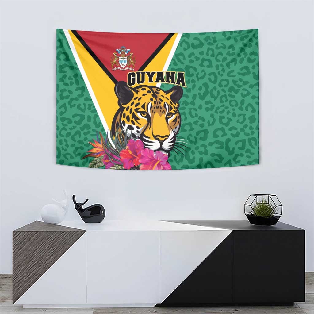 Green wall tapestry with jaguar head, Guyana text, and pink tropical flowers