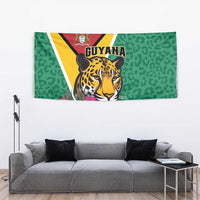 Green tapestry with jaguar face artwork and pink tropical flowers