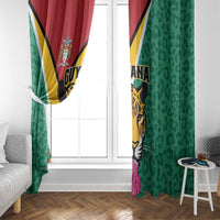 Green window curtain panels with Guyana jaguar and red-gold stripe accent, hanging at door