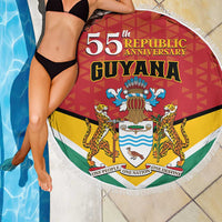 Round Guyana beach blanket with “55th Republic Anniversary” graphic and white tassel fringe