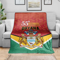 Republic anniversary blanket with 55th Guyana title, crest, and tri-color red-yellow-green.