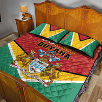 Flag-style Guyana quilt set with two pillows, red quilt top with crest, green and yellow