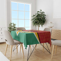 Guyana flag style tablecloth draped on dining table, red green yellow panel design