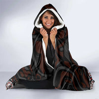 Hooded blanket with dark gray totem print and white sherpa-lined hood