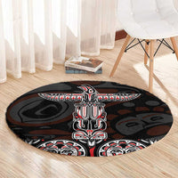 Black round carpet with centered totem figure and red-white patterned bands