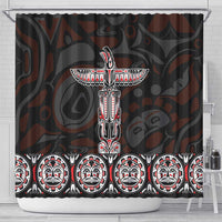 Black shower curtain showing central totem figure above a row of face masks