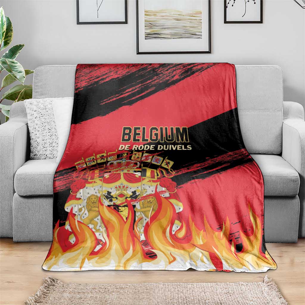 Belgium football team blanket draped on gray sofa with red, black and flame design