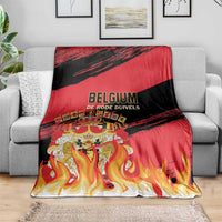 Belgium football team blanket draped on gray sofa with red, black and flame design