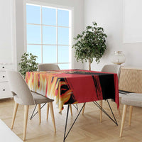 Belgium football tablecloth draped over dining table with red, black, and yellow flame design