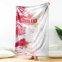 Poland football blanket draped on floor, red and white with eagle graphic and text